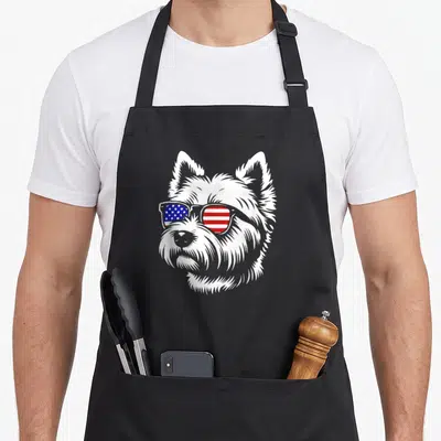 Flag westie apron - Cartoon white dog head wearing sunglasses with red white and blue flag lenses — shown on a black cotton canvas apron against a white background