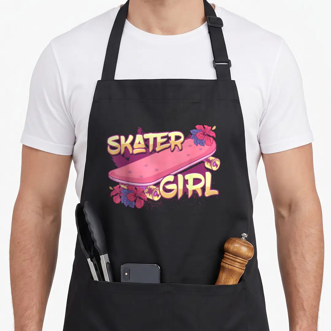 Funny skater skateboarding apron - Pink skateboard with SKATER GIRL text and two hibiscus flowers in cartoon style — shown on a black cotton canvas apron against a white background