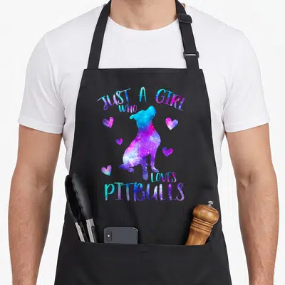 Pitbull dog apron - Galaxy colored pitbull silhouette with Just a Girl Who Loves Pitbulls text and scattered hearts — shown on a black cotton canvas apron against a white background