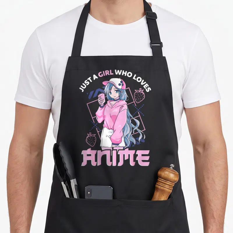 Anime apron for mom - Blue haired girl holding pink drink surrounded by strawberries and geometric grid — shown on a black cotton canvas apron against a white background