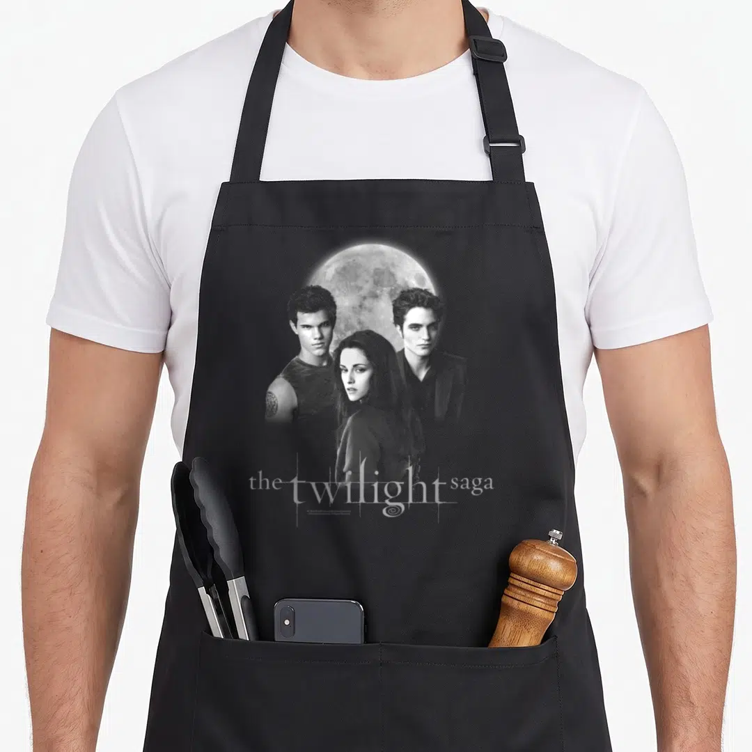 Jacob edwards aprons - Grey and white photo of three people and a moon with the twilight saga text at the bottom — shown on a black cotton canvas apron against a white background