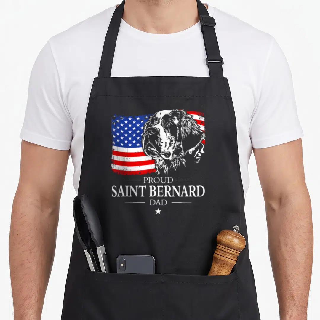 Proud saint american flag apron - Saint Bernard head over distressed US flag with stacked text reading PROUD SAINT — shown on a black cotton canvas apron against a white background