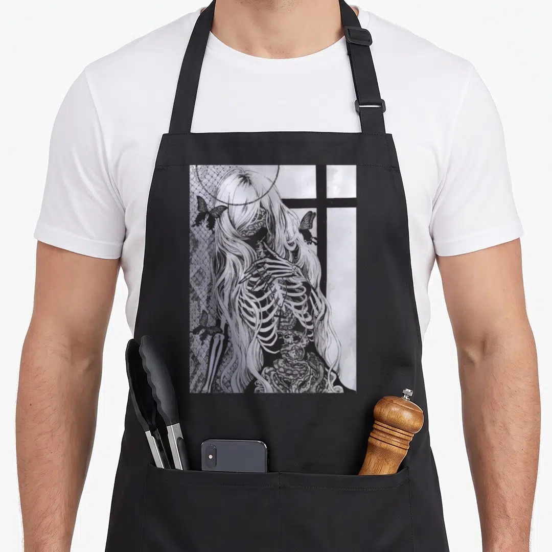 Dark skeleton apron - Female skeleton with long hair, halo, cross, butterflies, and netting in line art — shown on a black cotton canvas apron against a white background