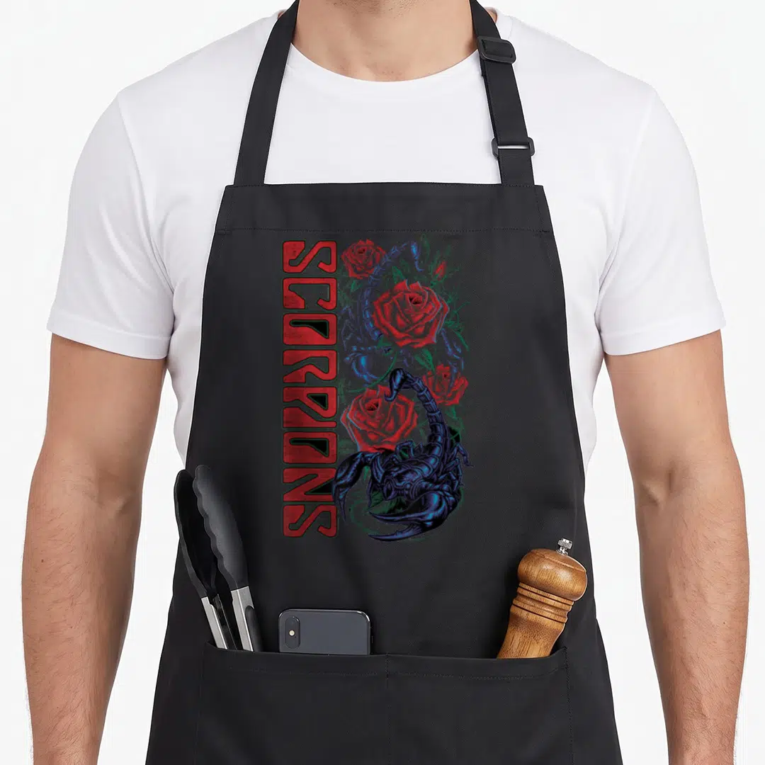 Ballad scorpion apron - Vertical red SCORPIONS text beside a dark blue scorpion and red roses — shown on a black cotton canvas apron against a white background