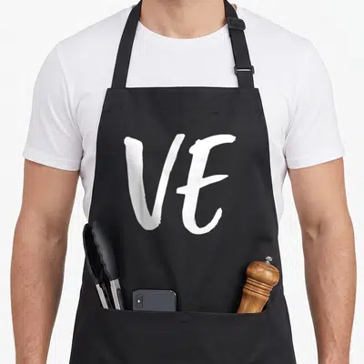 Couple valentine apron - White brush-style VE letters on a black background — shown on a black cotton canvas apron against a white background