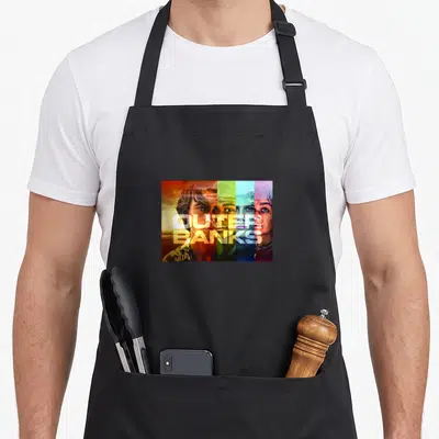 Outer character aprons - Four vertical color bands in orange green blue purple showing three faces with centered Outer — shown on a black cotton canvas apron against a white background