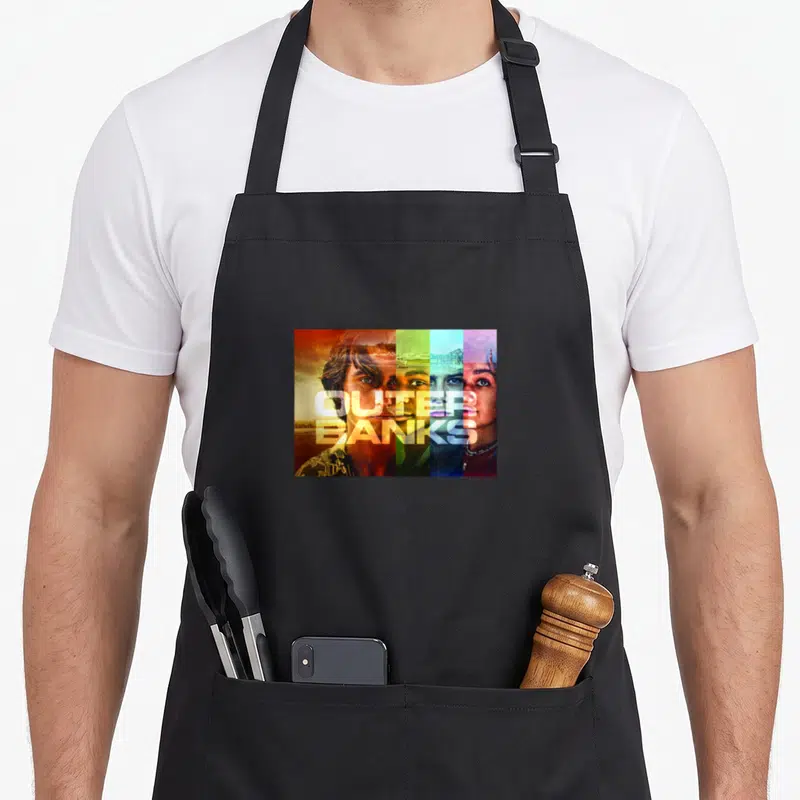 Outer character aprons - Four vertical color bands in orange green blue purple showing three faces with centered Outer — shown on a black cotton canvas apron against a white background