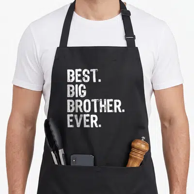 Cute best brother ever apron - White stacked text reading BEST. BIG BROTHER. EVER. in distressed font — shown on a black cotton canvas apron against a white background