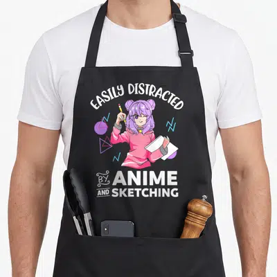 Easily distracted anime apron - Girl holding pencil and sketchbook surrounded by geometric shapes in white pink purple — shown on a black cotton canvas apron against a white background