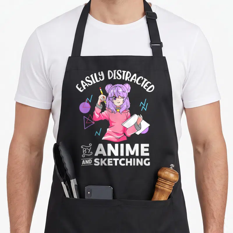 Easily distracted anime apron - Girl holding pencil and sketchbook surrounded by geometric shapes in white pink purple — shown on a black cotton canvas apron against a white background