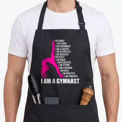 Gymnast handstand gymnastics apron - Pink gymnast silhouette next to white I AM SMART and I AM A GYMNAST text — shown on a black cotton canvas apron against a white background