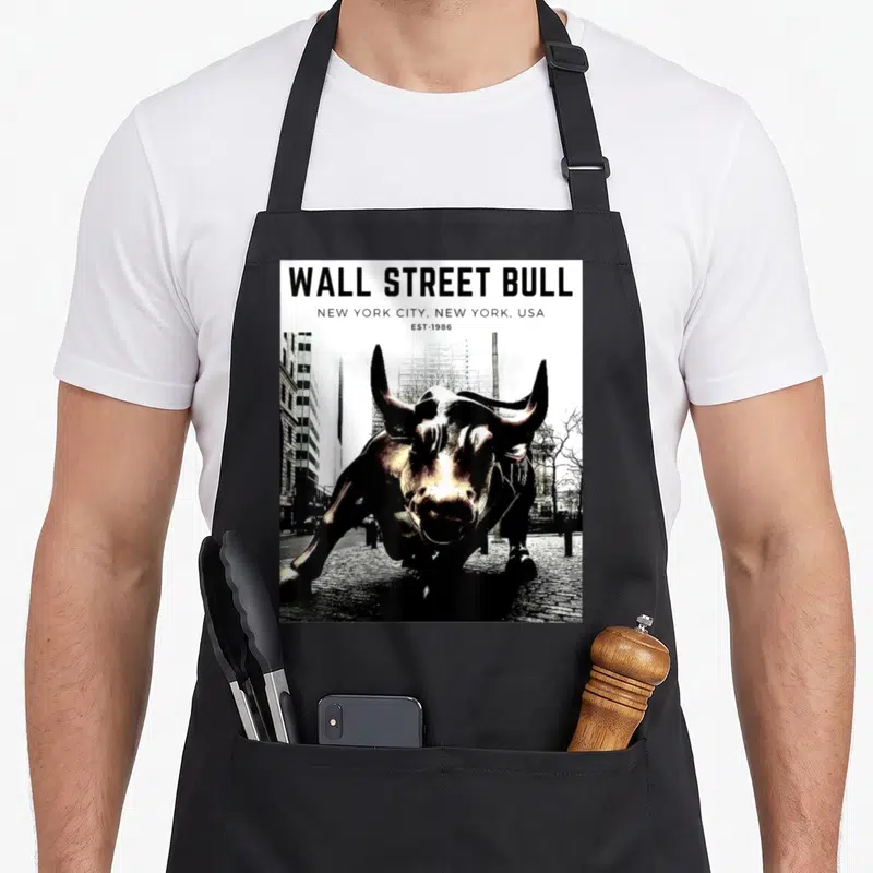 Trader stock show apron - Wall Street Bull statue photo with NYC text header — shown on a black cotton canvas apron against a white background