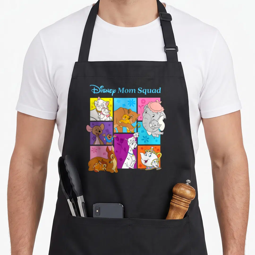 Famous my mother's apron - Disney Mom Squad text above colorful squares of animal mothers and a teapot — shown on a black cotton canvas apron against a white background