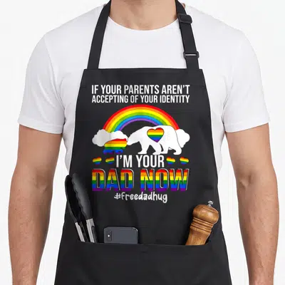 Lgbt bear apron - White bear with rainbow heart and text If Your Parents Aren't Accepting — shown on a black cotton canvas apron against a white background