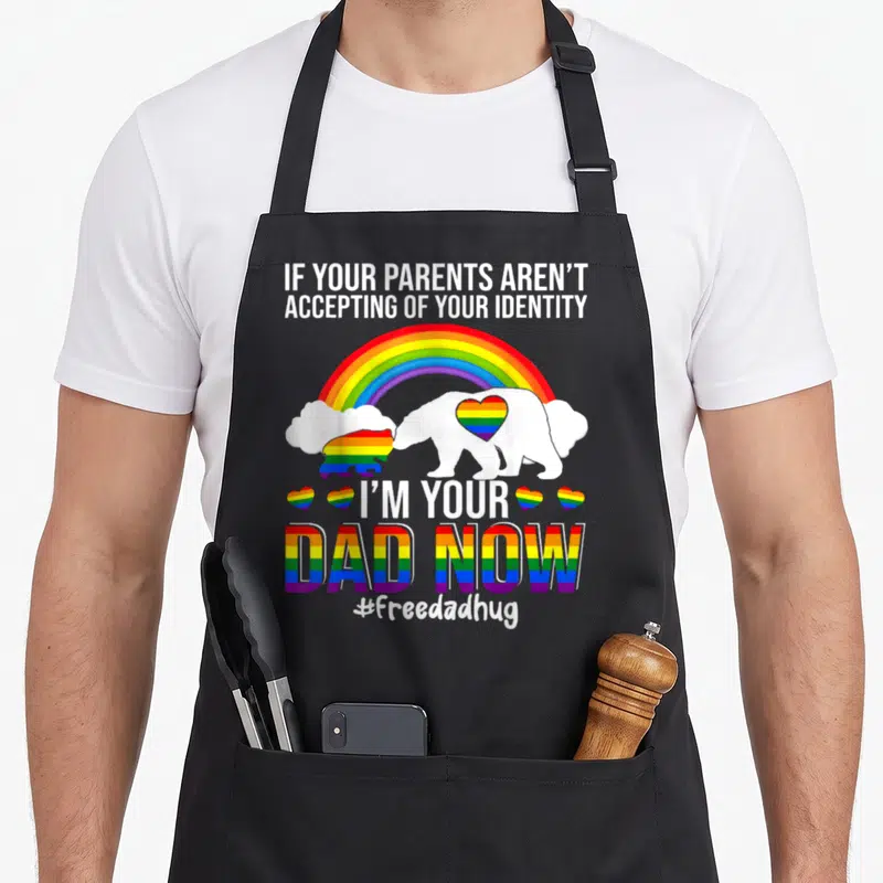 Lgbt bear apron - White bear with rainbow heart and text If Your Parents Aren't Accepting — shown on a black cotton canvas apron against a white background