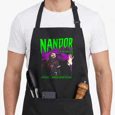 Shadow staten island apron - Nandor The Relentless retro print with green text and purple rectangle — shown on a black cotton canvas apron against a white background