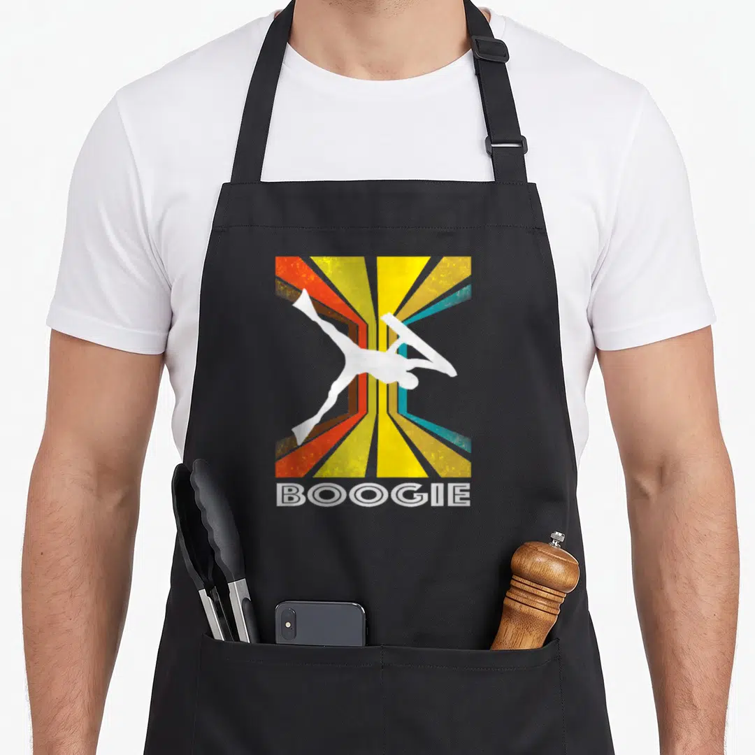 Boogie boarding apron - White dancer silhouette over yellow red and blue sunburst with BOOGIE text below — shown on a black cotton canvas apron against a white background