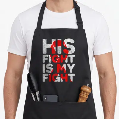 His congenital heart defect apron - Distressed text HIS FIGHT IS MY FIGHT with red and white diagonal stripes — shown on a black cotton canvas apron against a white background