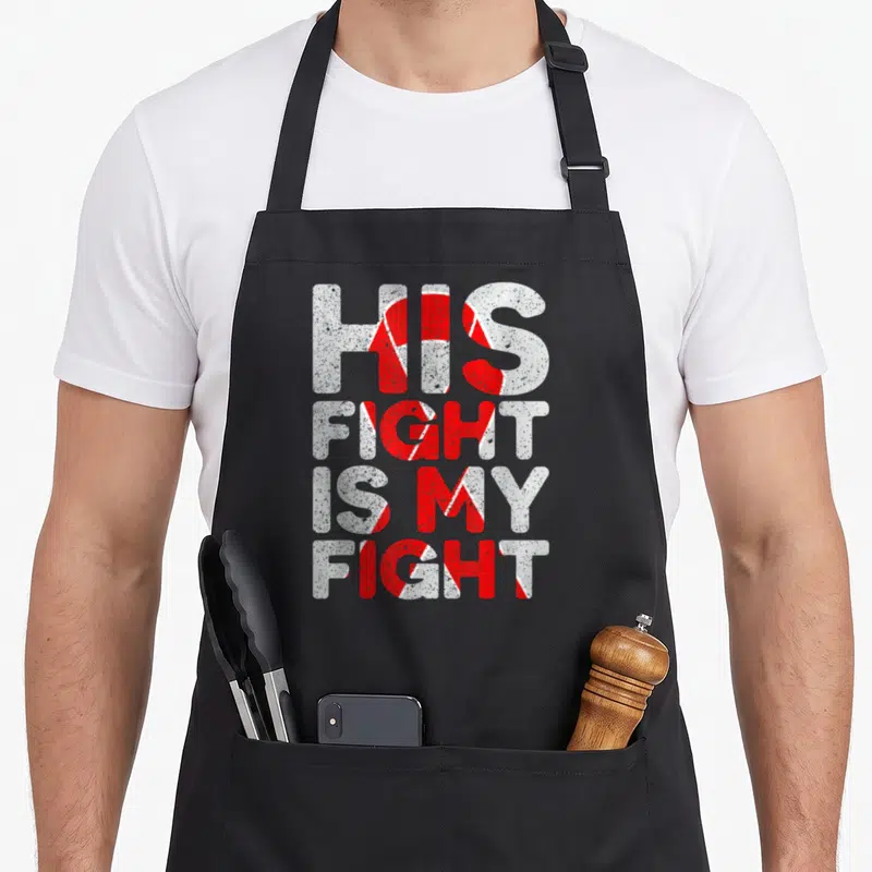 His congenital heart defect apron - Distressed text HIS FIGHT IS MY FIGHT with red and white diagonal stripes — shown on a black cotton canvas apron against a white background