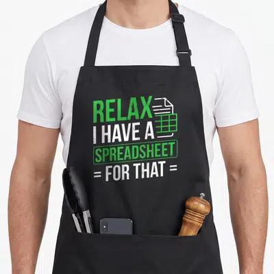 Relax spreadsheet accountant apron - Green and white stacked text reading RELAX I HAVE A SPREADSHEET = FOR THAT = — shown on a black cotton canvas apron against a white background