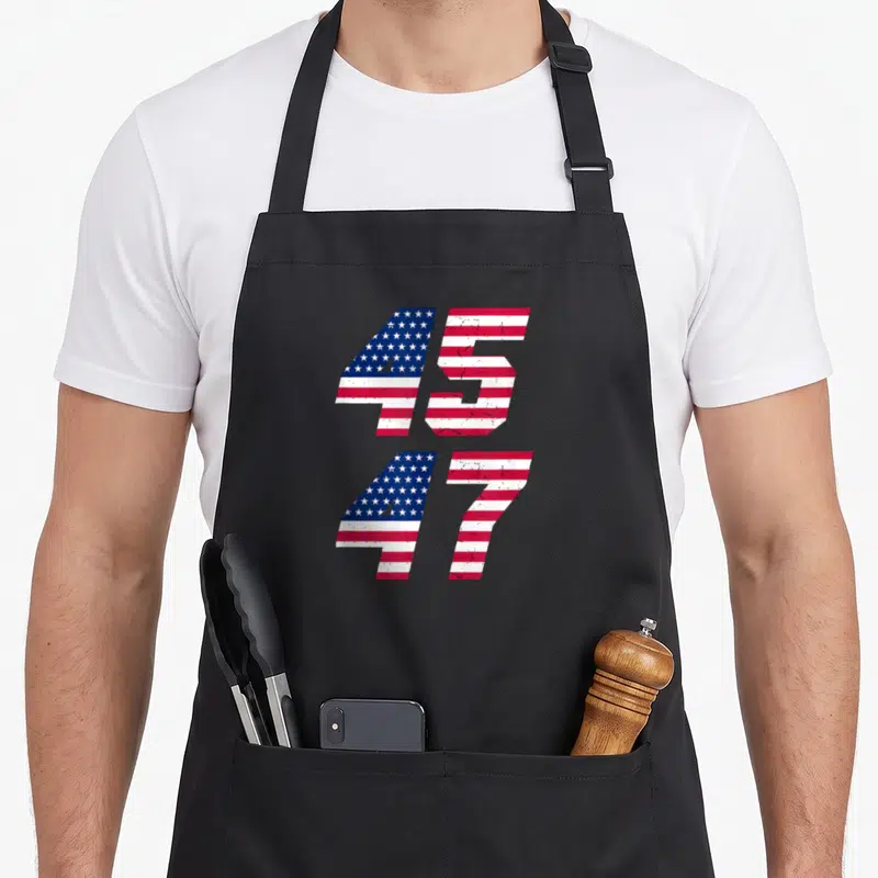 Comeback patriotic apron - Stacked numbers 45 and 47 filled with distressed red white and blue flag pattern — shown on a black cotton canvas apron against a white background