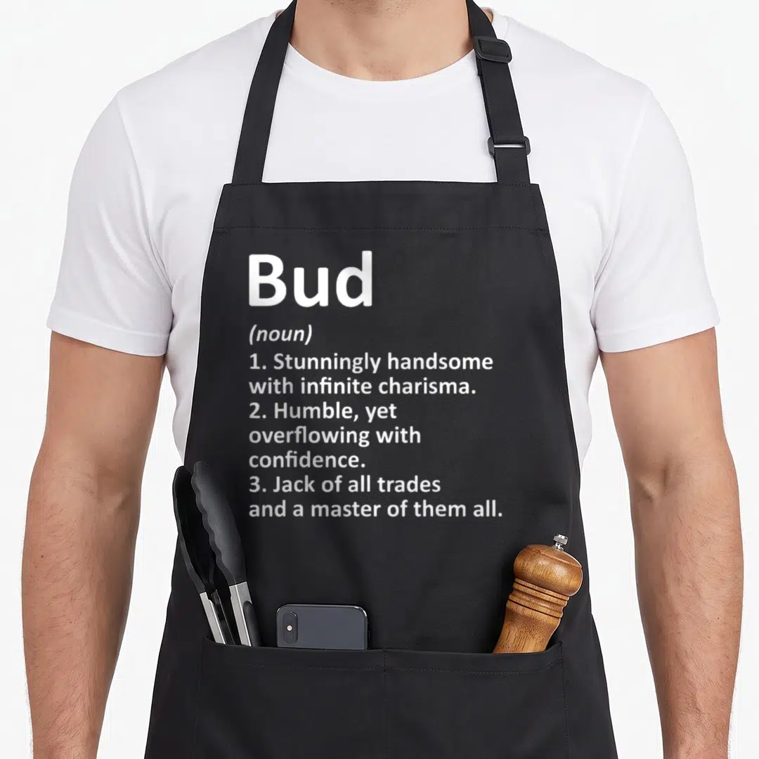 Bud father day aprons - White text defining Bud as handsome, humble, and a master of all trades — shown on a black cotton canvas apron against a white background