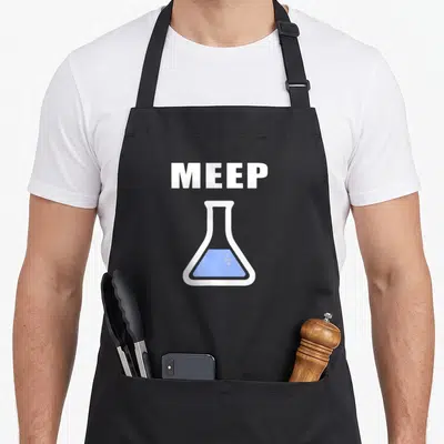 Meep test kitchen apron - White MEEP text above Erlenmeyer flask with blue liquid — shown on a black cotton canvas apron against a white background