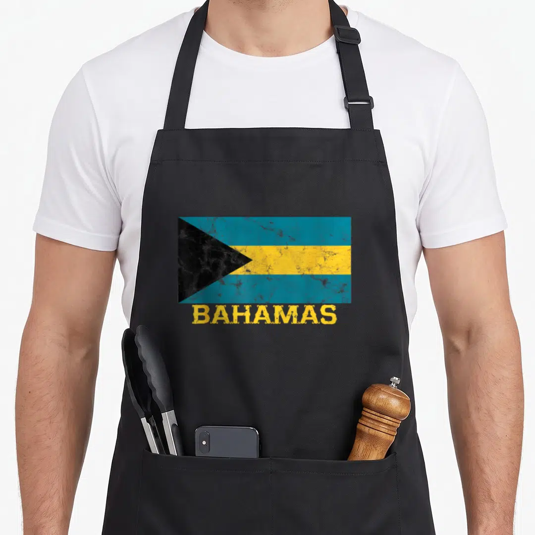 Bahamian pride apron - Distressed flag of Bahamas in blue yellow black with BAHAMAS text below — shown on a black cotton canvas apron against a white background