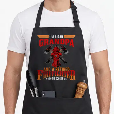 Grandpa firefighter aprons - Distressed fire hydrant with crossed axes and text I'm a Dad Grandpa Retired Firefighter — shown on a black cotton canvas apron against a white background