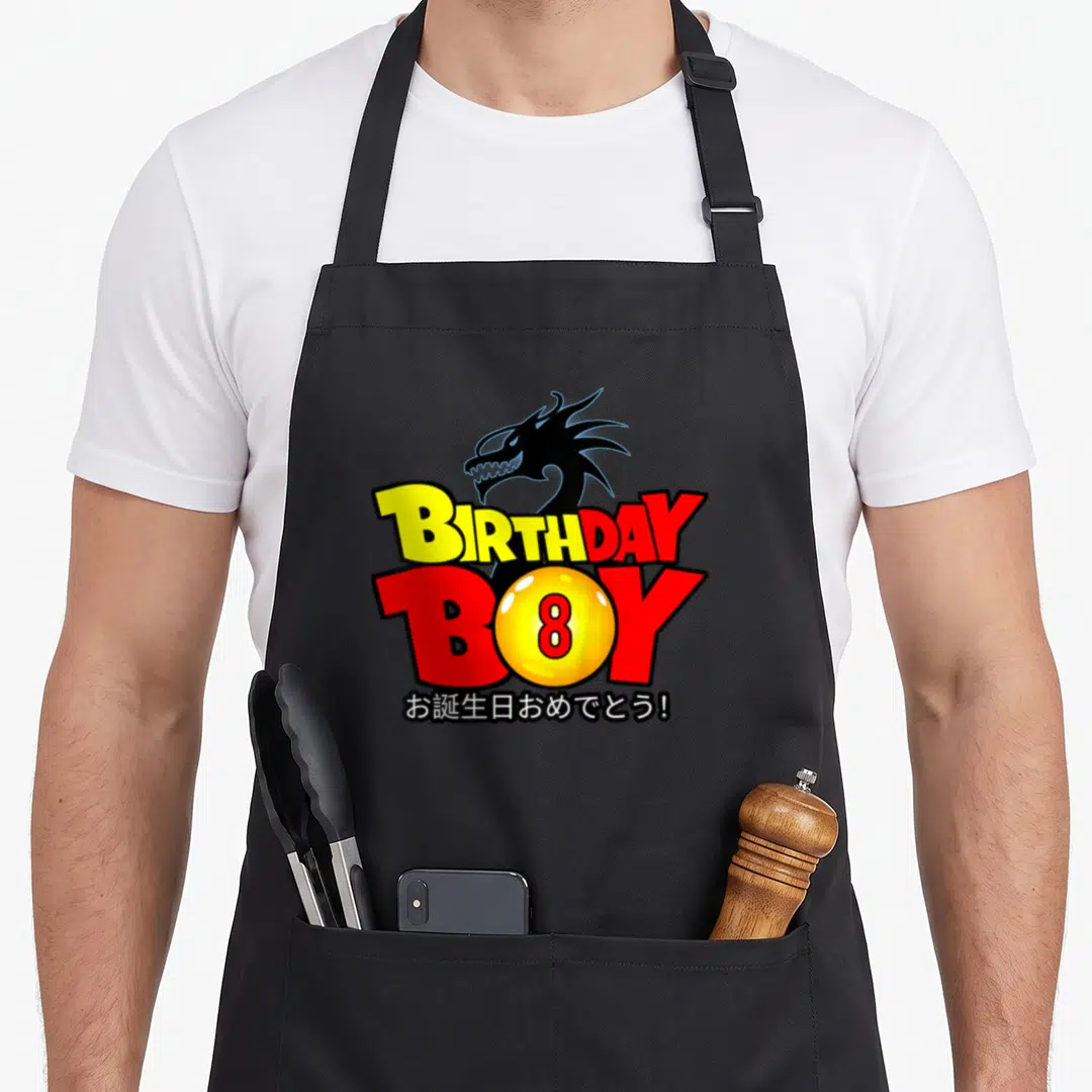 8th anime mom apron - Cartoon dragon head above BIRTHDAY BOY text and yellow sphere with number 8 — shown on a black cotton canvas apron against a white background