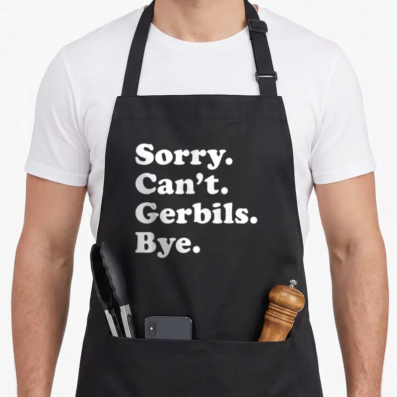 Gerbil apron or apron - White text reading Sorry Can't Gerbils Bye stacked vertically on dark background — shown on a black cotton canvas apron against a white background