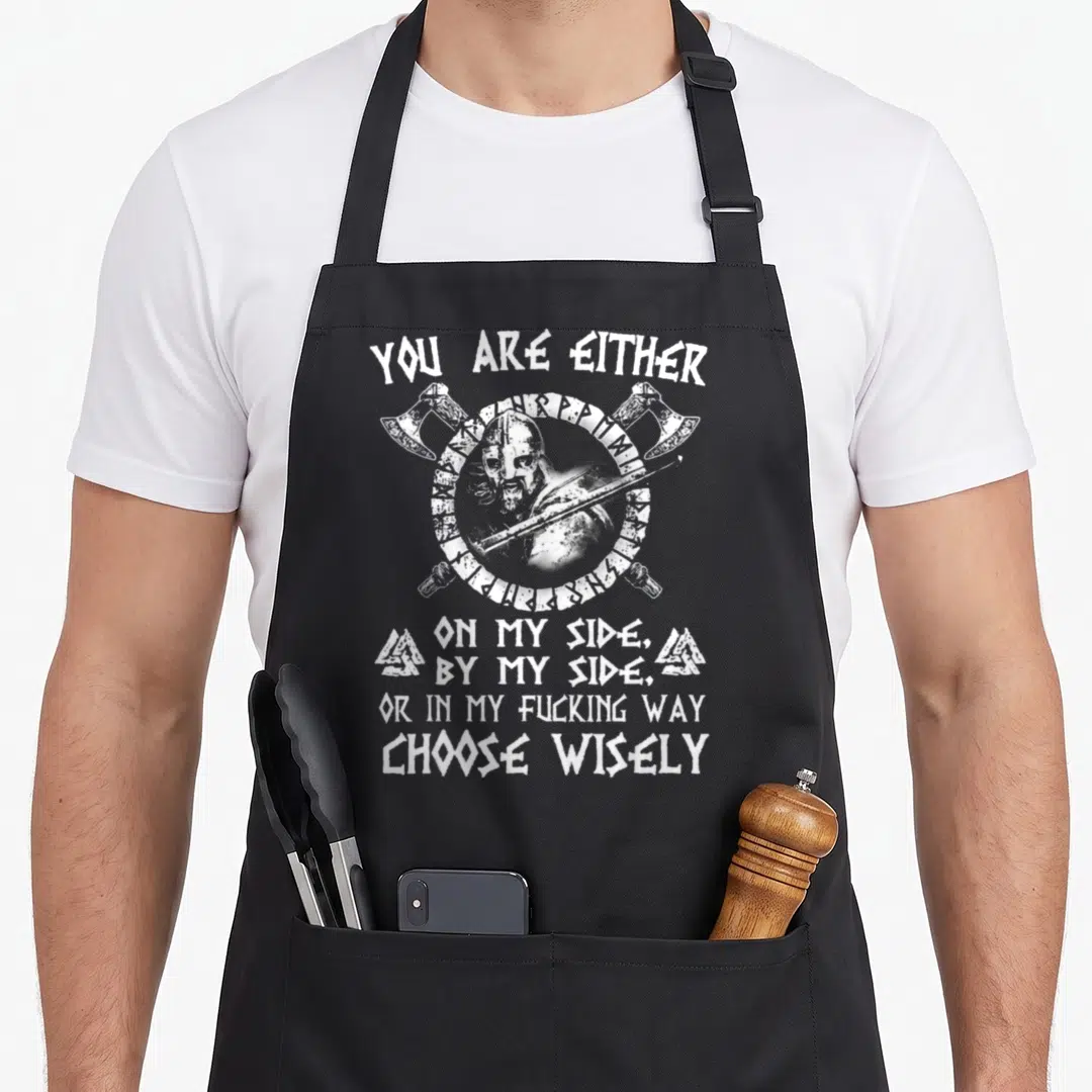 Either viking apron - White distressed viking emblem with crossed axes and warning text — shown on a black cotton canvas apron against a white background
