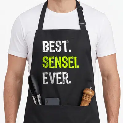 Sensei teacher apron - White and lime green stacked text reading BEST. SENSEI. EVER — shown on a black cotton canvas apron against a white background