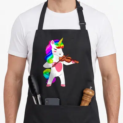 Violin unicorn apron - Standing white unicorn with rainbow mane playing brown violin horizontally in cartoon style — shown on a black cotton canvas apron against a white background