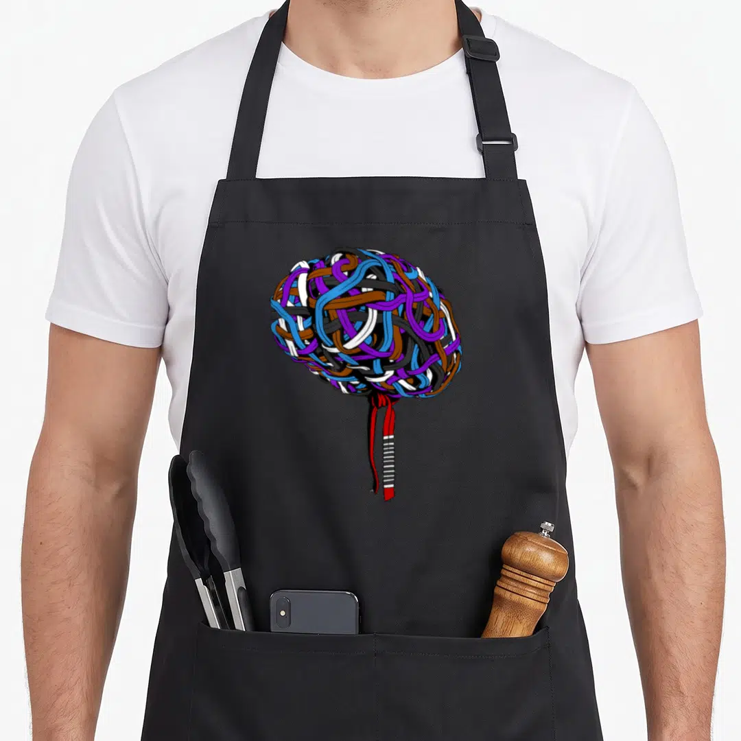 Jjb brazilian jiu jitsu apron - Spherical tangle of blue purple brown red white and black martial arts belts tied — shown on a black cotton canvas apron against a white background
