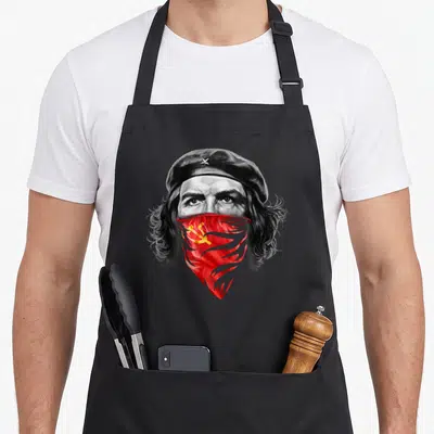 Che bandana apron - Realistic portrait of a man in a black beret with a red bandana featuring a yellow hammer — shown on a black cotton canvas apron against a white background