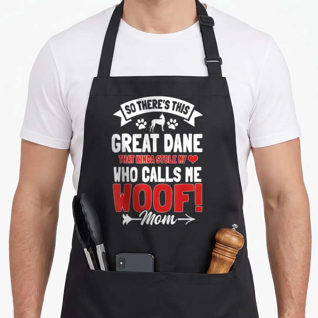 Gentle mother's day aprons - White and red text reading So There's This Great Dane Woof Mom with dog silhouette and paw — shown on a black cotton canvas apron against a white background
