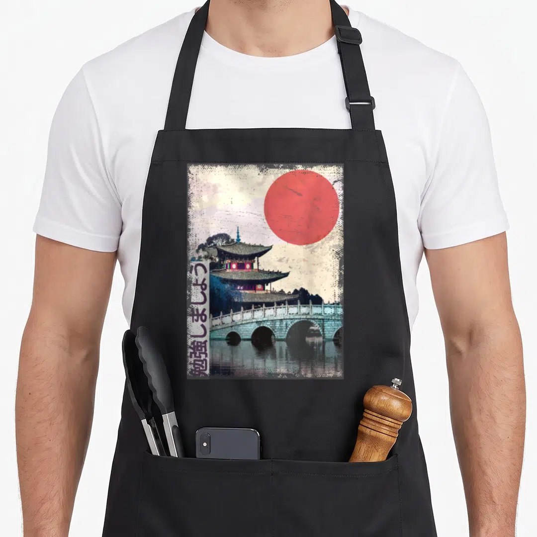 Temple japan apron - Vintage pagoda and bridge with red sun and vertical Japanese text meaning let's study — shown on a black cotton canvas apron against a white background