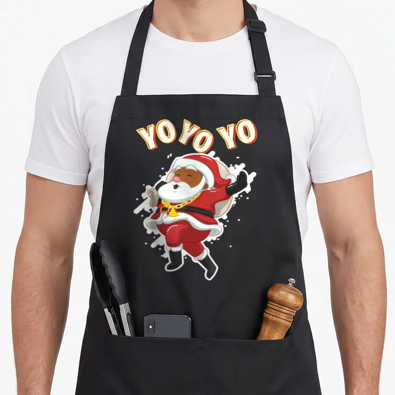 African christmas santa claus apron - Cartoon Santa with gold chain and arched YO YO YO YO text in red and orange — shown on a black cotton canvas apron against a white background