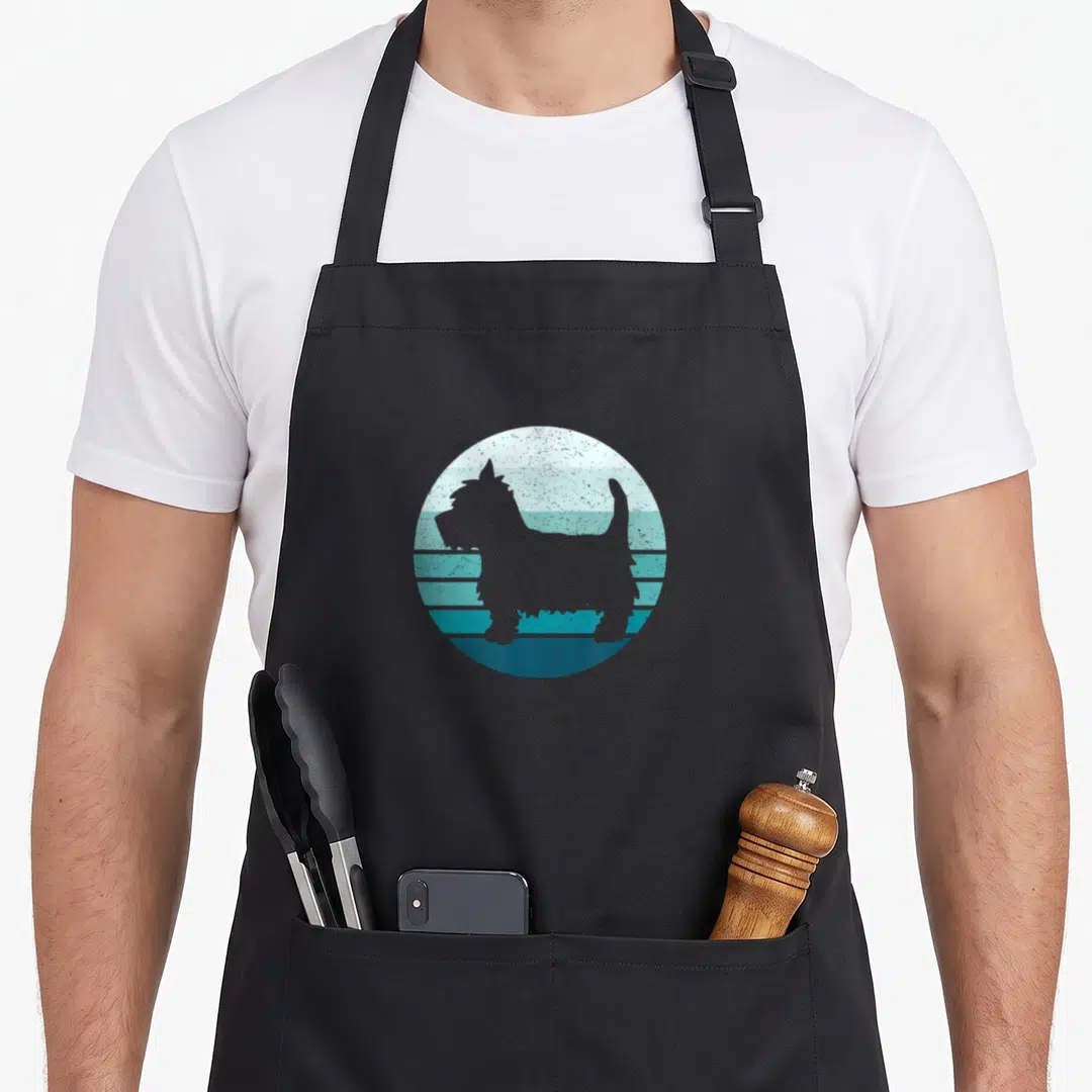 Terrier dog westie apron - Grey dog silhouette inside a circle of blue and white horizontal stripes with retro texture — shown on a black cotton canvas apron against a white background