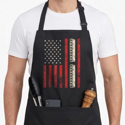 Harmonica american flag apron - Distressed US flag with comb-shaped stripes in red and white — shown on a black cotton canvas apron against a white background