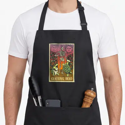 Terrapin vintage dead apron - Retro skeleton and two turtles with GRATEFUL DEAD text in red and green — shown on a black cotton canvas apron against a white background