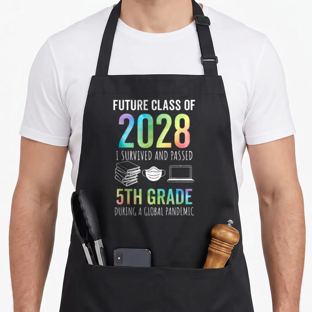 Future graduation year apron - Future Class of 2028 5th Grade Pandemic text with book mask laptop icons rainbow gradient — shown on a black cotton canvas apron against a white background