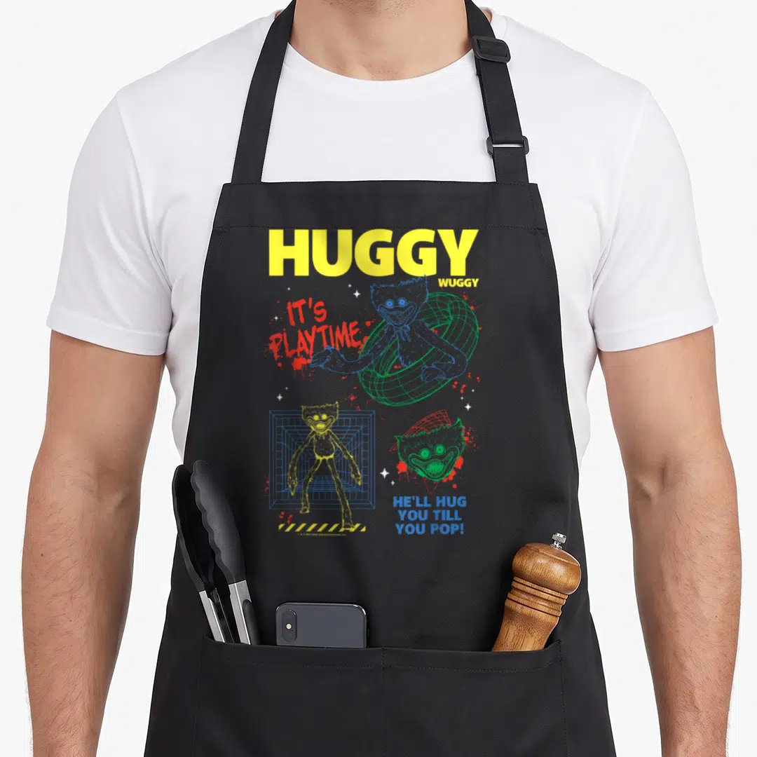 Playtime poppy apron - Huggy Wuggy text and three colorful cartoon character illustrations with grids and splatters — shown on a black cotton canvas apron against a white background