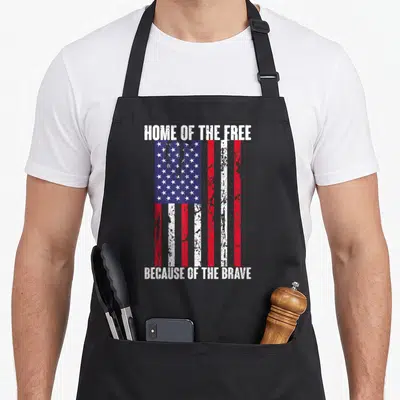Free american flag apron - Vertical distressed USA flag with Home of the Free Because of the Brave text — shown on a black cotton canvas apron against a white background