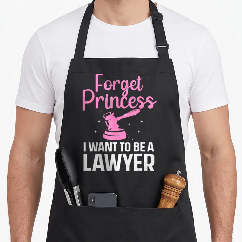 Graduate lawyer apron - Pink gavel with white sparkles and text Forget Princess I WANT TO BE A LAWYER — shown on a black cotton canvas apron against a white background