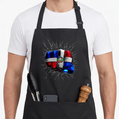 Flag dominican republic apron - Fist painted in blue red and white flag cracking through grey surface — shown on a black cotton canvas apron against a white background