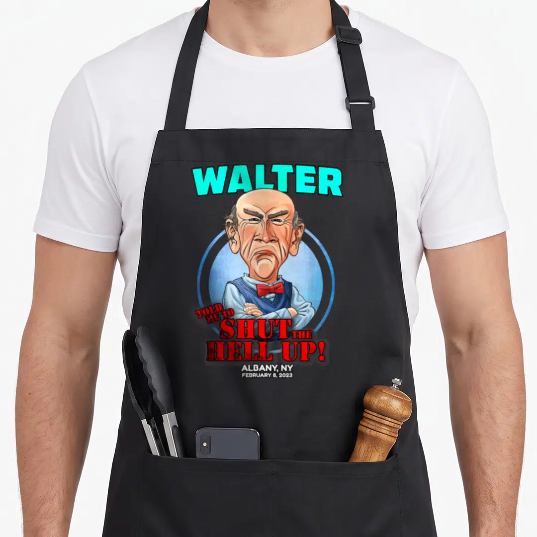 Walter albany apron - Caricature of a man with arms crossed surrounded by red text WALTER TOLD ME TO SHUT THE HELL UP — shown on a black cotton canvas apron against a white background
