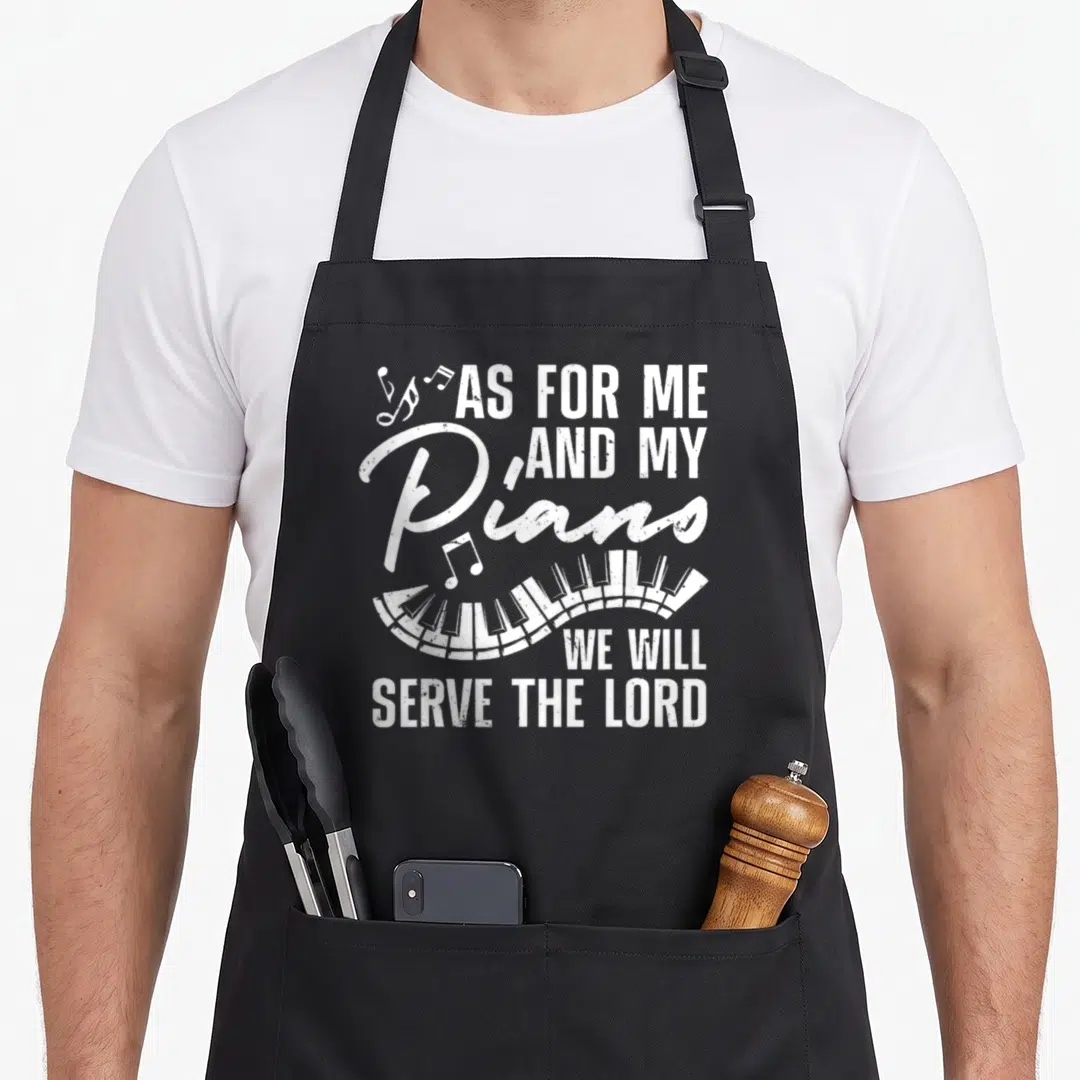 Teacher piano apron - Distressed white piano keys and As For Me And My Pianos We Will Serve The Lord text — shown on a black cotton canvas apron against a white background