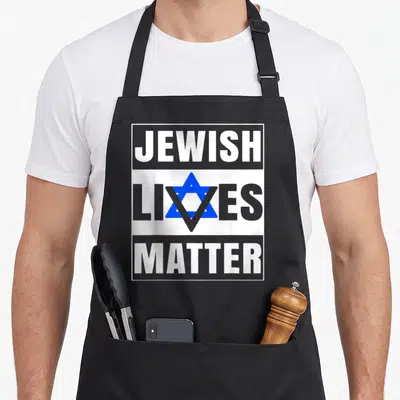 Live jewish apron - JEWISH LIVES MATTER text with blue Star of David on grey and white blocks — shown on a black cotton canvas apron against a white background